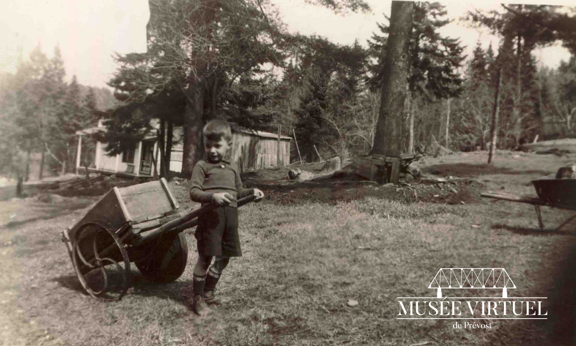 1. Un enfant voisin de la famille Brosseau vers 1930-40. De fabrication artisanale, les 2 roues non identiques illustrent bien qu'on se débrouillait avec ce qu'on avait - Collection de la famille Brosseau
