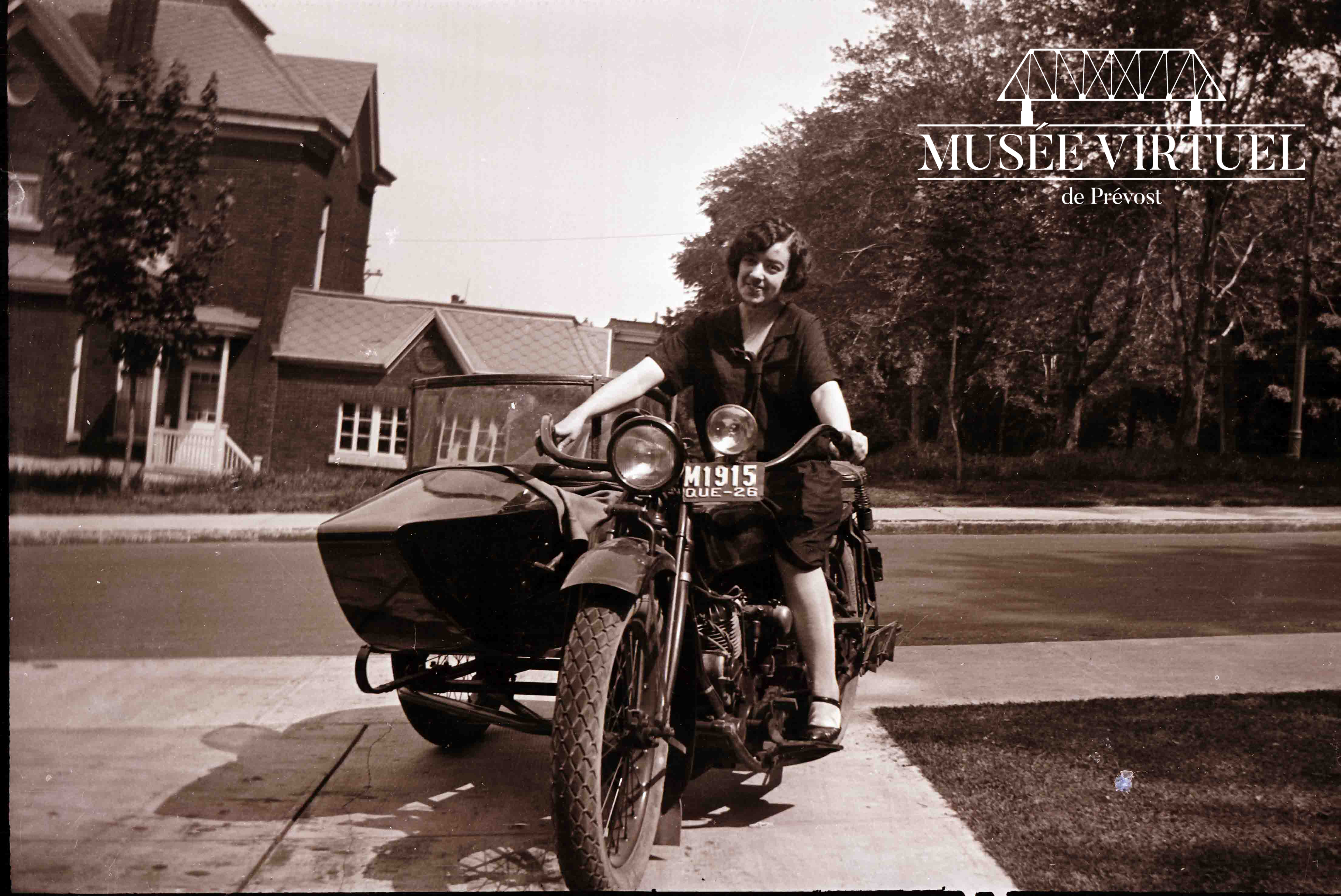 4. Alice Lecours prend la pose sur la moto d'Isaïe lors d'un voyage à Saint-Jérôme en 1926 - Collection de la famille Brosseau